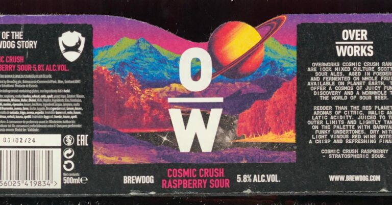 Cosmic Crush Raspberry beer label from OverWorks & BrewDog: A ringed planet floats above a colorful mountain range with purple sky and orange ground; large white letters 'O' over 'W' overlay the scene.