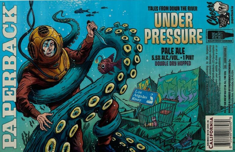 Under Pressure beer label from Paperback: A diver in a yellow helmet struggles with a giant blue octopus underwater near graffiti-covered ruins and fish.