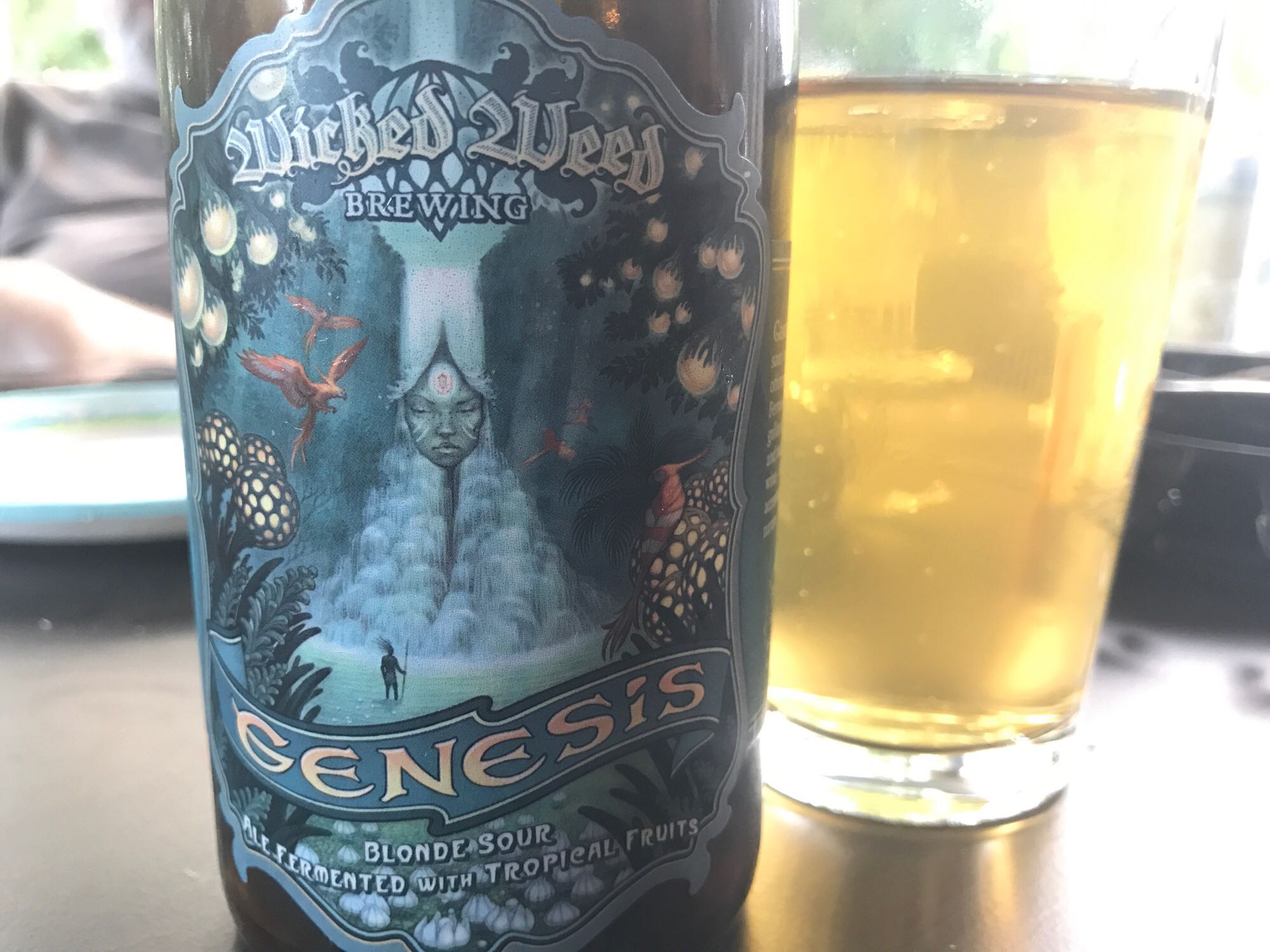 Wicked Weed Genesis bottle with a glass