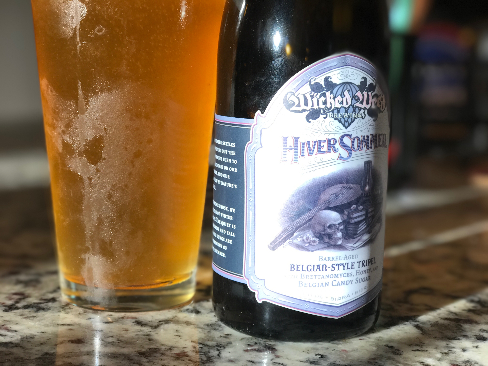 Wicked Weed Hiver Sommeil bottle with a glass