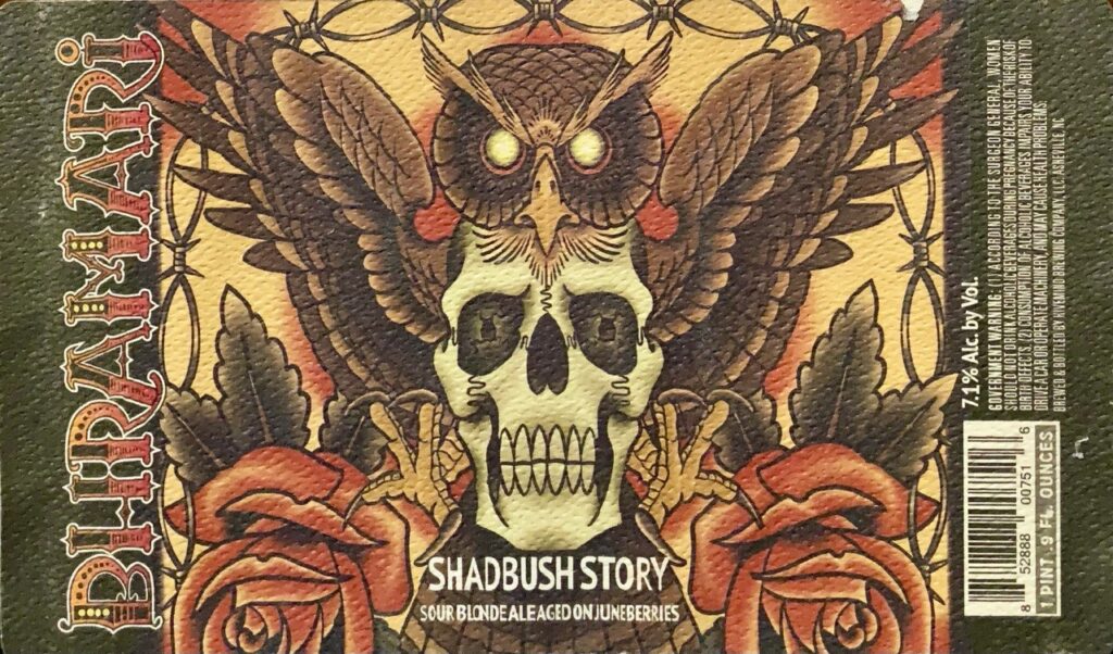 Bhramari The Shadbush Story label with owl, skull, roses, wings, and barbed wire