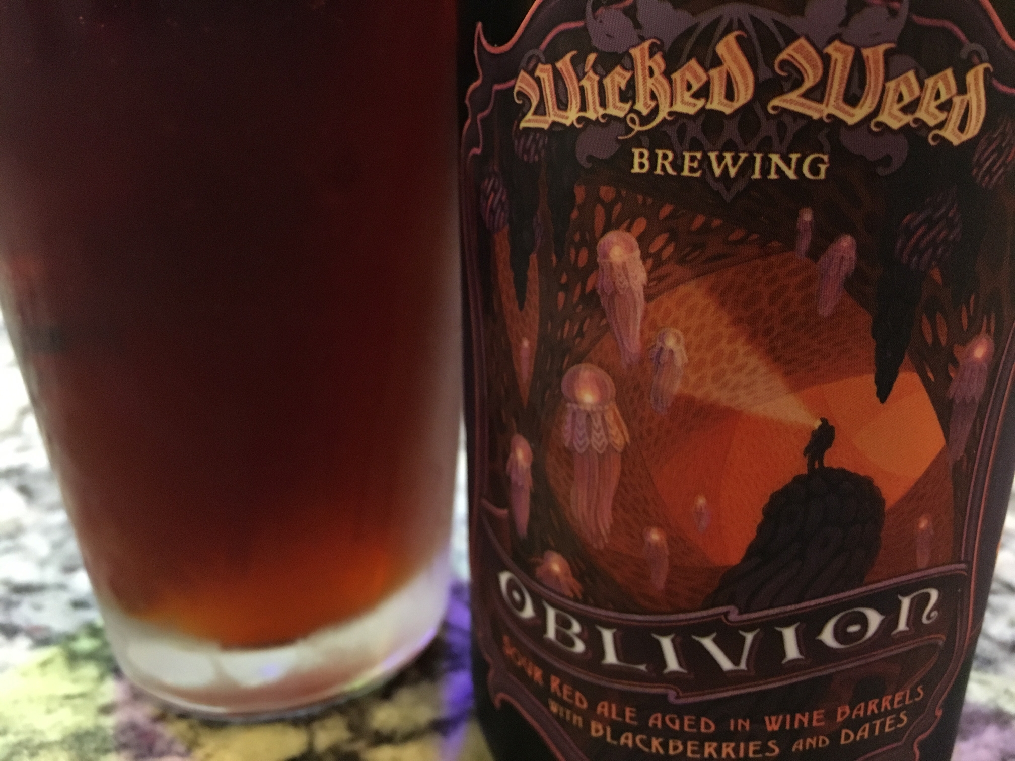 Wicked Weed Oblivion bottle with a glass